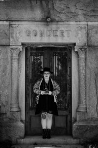 Photographer honoring her grandparents at their gravesite with mementos from their lives.