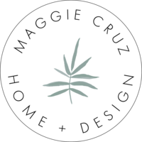 white circle with "Maggie Cruz Home and Design" arched on top and bottm wit hlight green plant icon in center