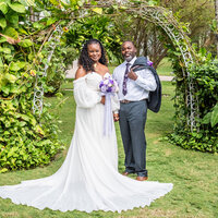 Bride and groom standing before lush floral arrangements after their ceremony, featured in Khalia and Demetrius’s review of White House Wedding Photography.