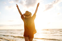 A woman feeling rested and recovered, gazing out to a new horizon.