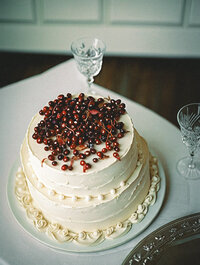 A wedding cake with fruit on top representing the diversity of vendors at The Crush Collective wedding expo.