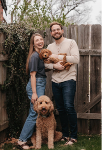 Couple with their two golden doodles in their Wichita backyard