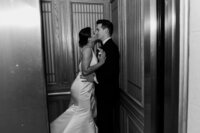 couple kisses in city hall elevator