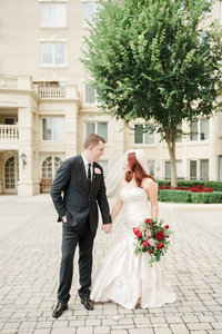 Newly married couple holding hands in Annapolis Maryland wedding photographed by Charlottesville Virginia Wedding Photographer Amanda Adams