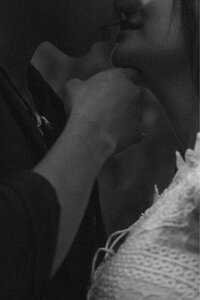 Close up black and white shot of an engaged couple almost kissing.