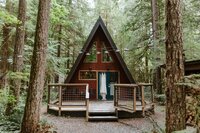 A-Frame in the woods with bridal dress hanging