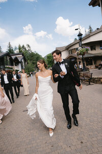 bride and groom walking in open field at jackson hole wyoming wedding