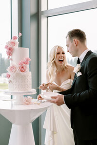 Modern wedding style, bride and groom cutting blush and white wedding cake by Yvonne's Delightful Cakes - Modern Chic Wedding at The Sensory in Canmore Alberta, designed and planned by Rebekah Brontë.