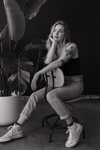 Colorado elopement photographer sitting in a chair with her head resting in her hand