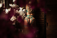 client in a green strappy lingerie outfit at Elevation Boudoir