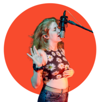 Allison singing into a microphone in the studio