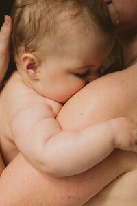 Baby hugging parent