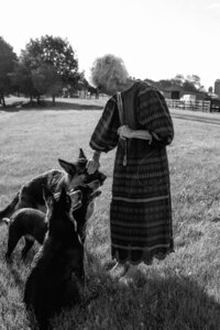 Sasha training two dogs to obey commands in black and white