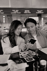 Couple elopement photos on Block Island with them eating noodles making funny faces