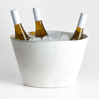 Marble ice bucket with ice and three bottles of wine inside. 
