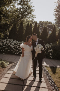 bride and groom share a kiss under veil