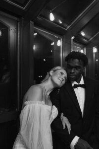 black and white photo of bride leaning on grooms shoulder