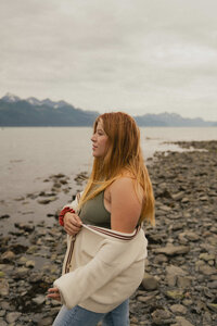 Jamie Tobin posing with an old film camera that she uses during clients elopements and micro weddings