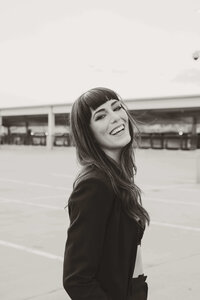 Black and White Photo Desiree Electric Honey Photography Laughing on Rooftop in Black Jacket