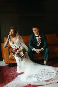 Two brides posing at their wedding at Juniper Mountain House