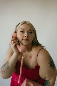 Photographer brand photo in a studio with pink corded landline
