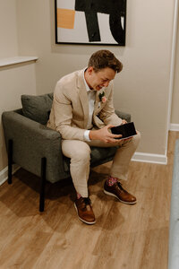 groom looking at gifts