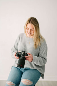 Blonde Photographer looking at camera