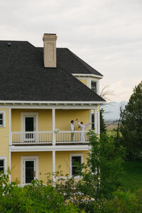 Groom spinning bride on the balcony at somers mansion near flathead lake