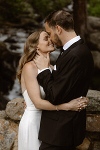 A bride and groom embracing after their elopement ceremony in breckenridge.