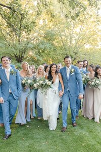 Scottsdale-Wedding-Photographer-and-Videographer-Private-Residence-Bride-and-Groom-walking-with-bridalparty-HuffoWed-1495