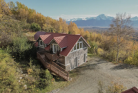 AirBnb in Palmer, AK, with mountains in the background and fall color in the trees.