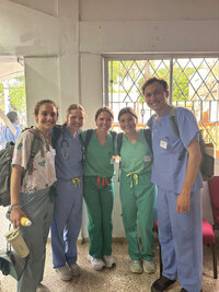 group of students standing in scrubs