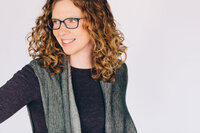 Virtual assistant client wearing blue polka dot shirt against wooden background