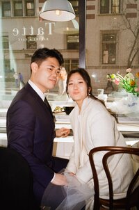 A candid and silly photo on color 35mm film with direct flash of a couple making funny faces at the camera - a quiet, intimate moment captured by a film wedding photographer.