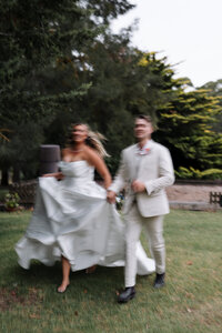 Blurry photo of bride and groom running hand in hand