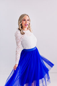white woman dressed in a white lace top and blue flowy skirt - brand photography in Chicago Ill