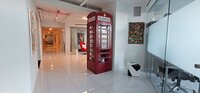 A hallway with a red telephone booth