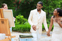 Wedding artist Elyse Stokes surprising bride and groom with their wedding painting, eliciting emotional and joyful response