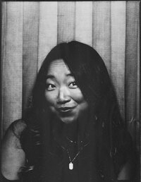Self-portrait of Southern California wedding photographer, Lauren Ahn, cropped to a single frame from a vintage photobooth, capturing a retro, nostalgic vibe with classic lighting and a square format.