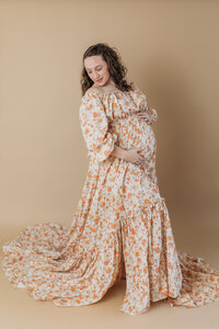 Expecting mom in floral dress in studio photography session
