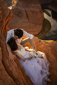 A couple engaged at the Horseshoe Bend overlook, with the iconic bend in the Colorado River creating a picture-perfect setting.