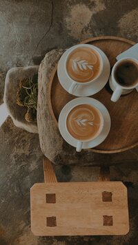 two cups of cafe latte on a wooden tray in south korea