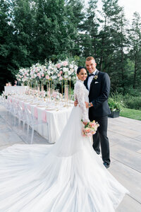 Newport Wedding Photographer | Rhode Island Caprio Captured Photography | Couple standing close together with a stunning table setting in the background