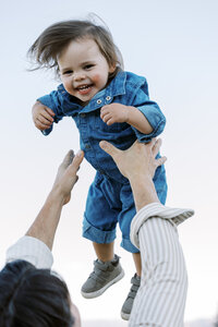family throwing baby in the air in mammoth lakes