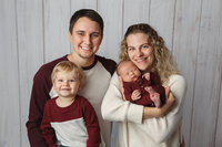 Studio portrait of family with their newborn son and his big brother