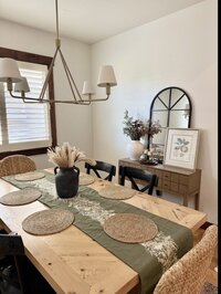 Close-up of dining room with layered textiles and warm, modern decor.