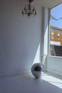 Disco ball prop in an all-white photography studio in Troy, Missouri
