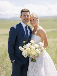 bride and groom laughing in an orchard