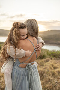 mum and daughter on cliff