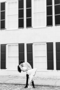 Engaged couple kissing in front of building by photographers chicago Allison Francois